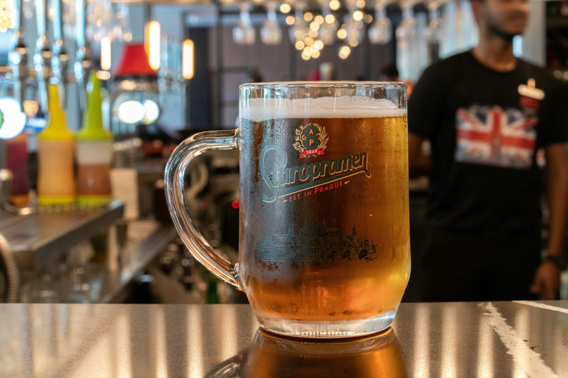 a glass of beer on a bar